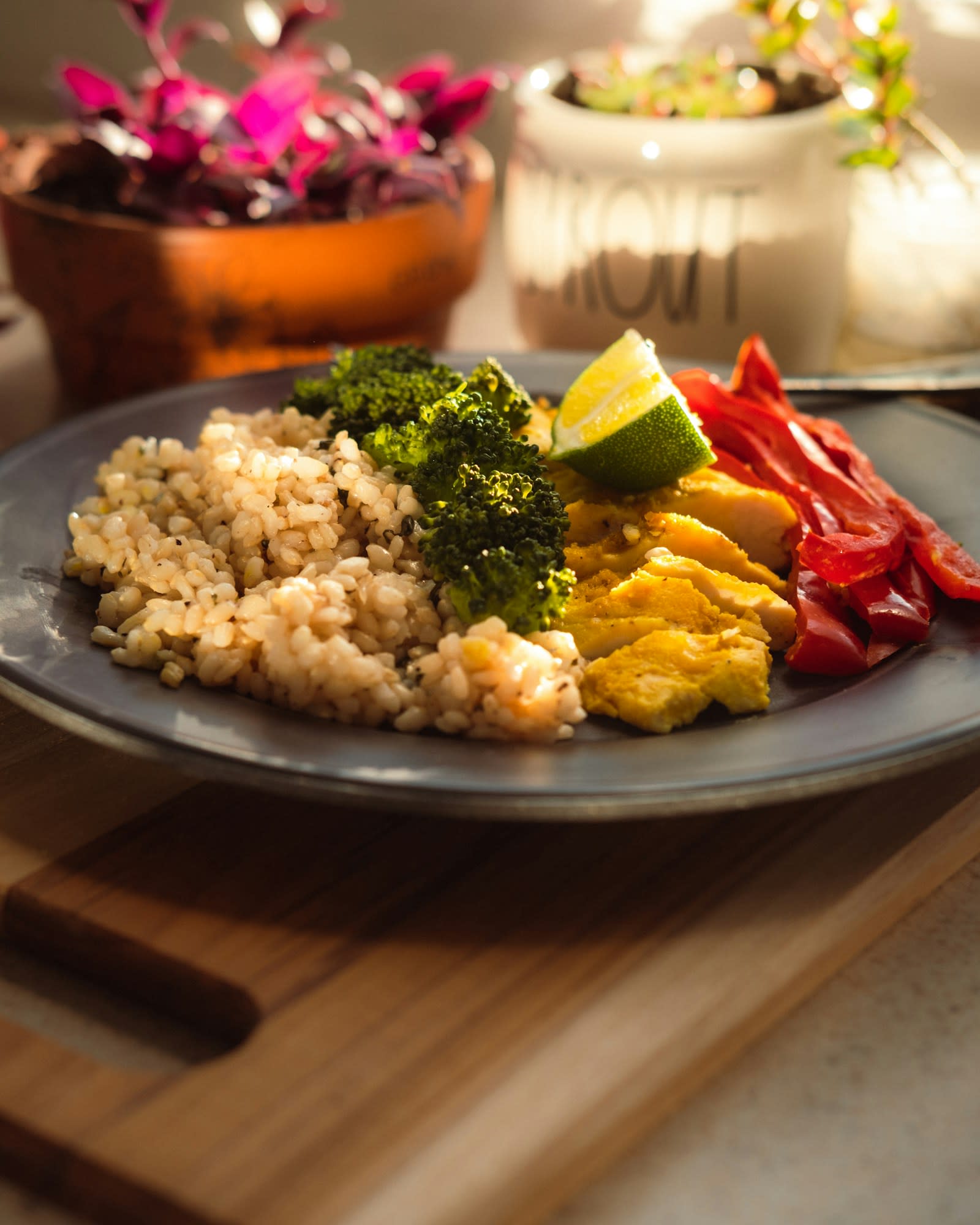 A plate of brown rice, broccoli, peppers and egg