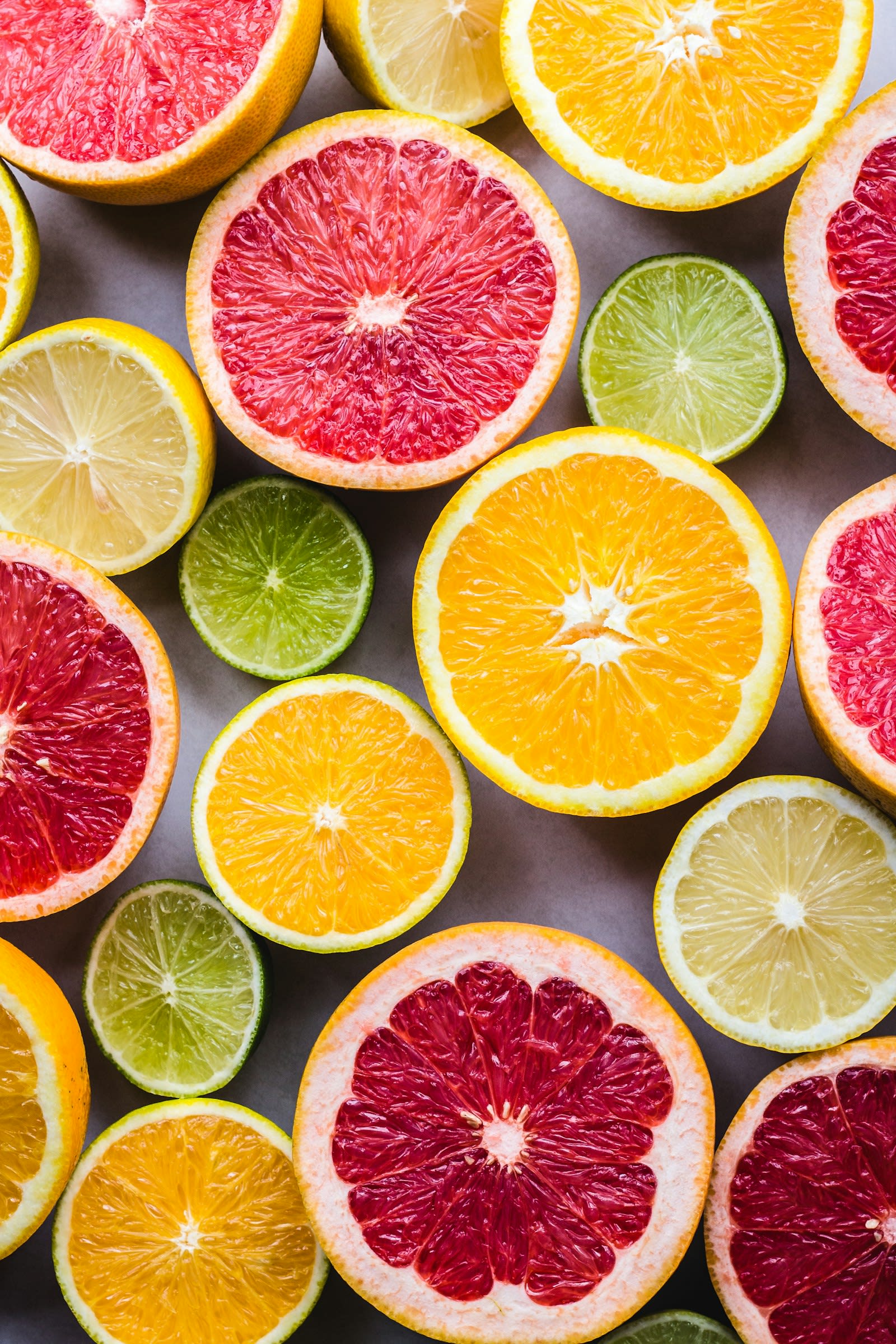 Halved citrus fruits: oranges, grapefruit, limes and lemons